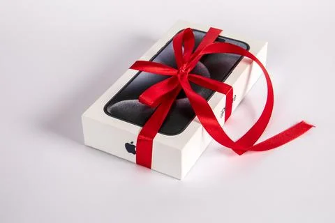 Box of the Iphone 15 Pro on on a white background. Gift with a red ribbon Stock Photos