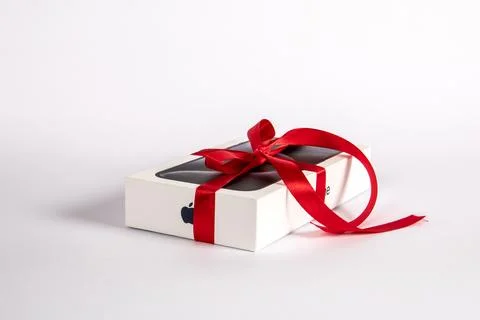 Box of the Iphone 15 Pro on on a white background. Gift with a red ribbon Stock Photos