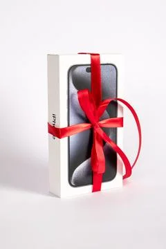 Box of the Iphone 15 Pro on on a white background. Gift with a red ribbon Stock Photos