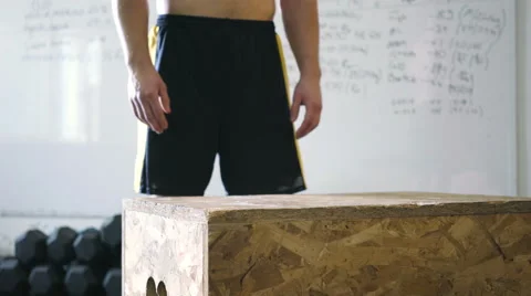 Box jump exercise - closeup of young athletic man doing workout at gym Stock Footage 65279107