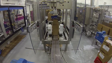 Box loader in busy factory bottling warehouse on conveyor B Stock Footage 124217160