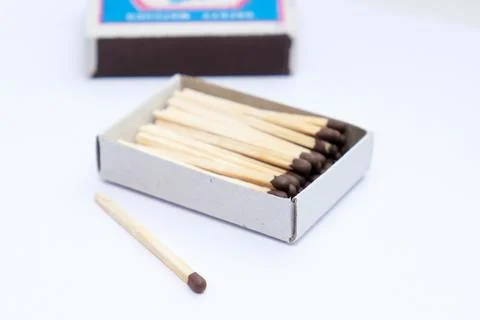 A box of matches with a single match left out of the box Stock Photos