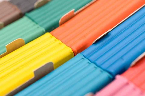 A box with a multi-colored plasticine of elongated shape. Stock Photos