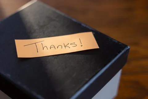 A box with a note that says "Thanks" written on it Stock Photos