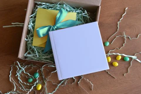 Box is opened with a gift book with white color and candy Stock Photos