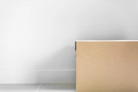 Box package parcel for post delivery on floor with grey wall background. Obje 写真素材