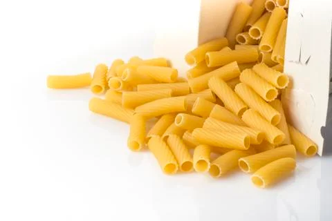 Box of pasta rigatoni upside down on the table Stock Photos