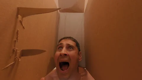 The box is pierced with four knives, in which the guy's head is clamped. Quest. Stock Footage 317177148