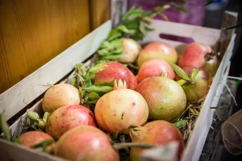 Box of pomegranates Stock Photos