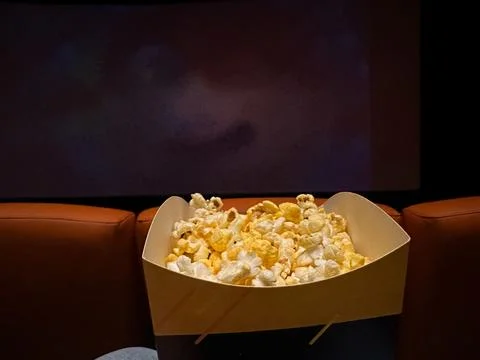Box of Popcorn in Empty Movie Theater Stock Photos