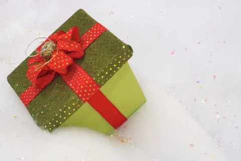 Box for present or gift on snow with red ribbon bow Stock Photos