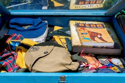A box of rare old boy scout items are a treasure trove for a collector. Stock Photos