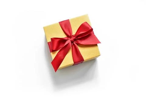 Box with a red ribbon on a white background with a shadow. presentation of .. Stock Photos