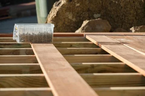 A box of screws placed on an unfinished deck Stock Photos