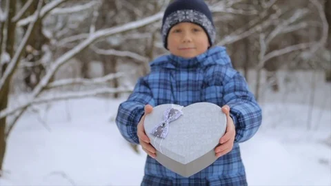 A box in the shape of a heart in the hands of a boy Stock Footage 84759707