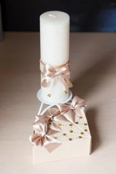 Box-shaped piece of cake and candle Stock Photos