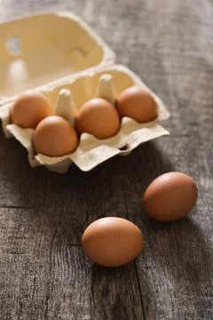 Box with six eggs on the old rustic background Stock Photos