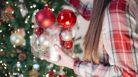 Box with sparkling winter decorations in hands of elegant woman with long brown Video stock 250650369