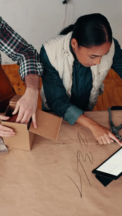 Box, tablet and people packing for delivery, shipping and ecommerce in leather Stock Footage 332929827