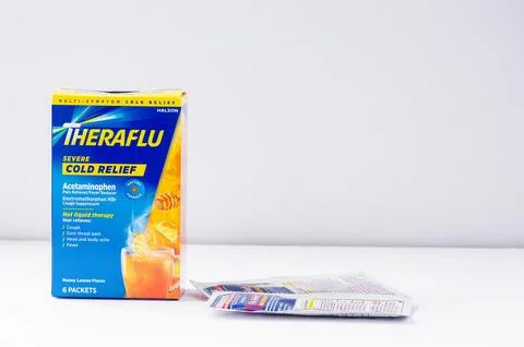 A box of Theraflu Severe Cold Relief with two packets on a white background Stock Photos
