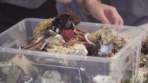 Box with threads and decorations. She chooses what to take Stock Footage 70965705