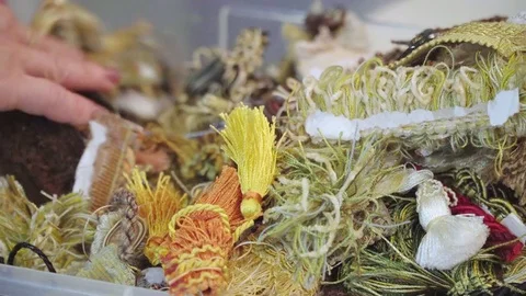 Box with threads and decorations. She chooses what to take Stock Footage 70971068