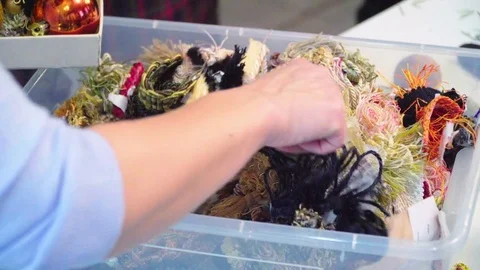 Box with threads and decorations. She chooses what to take Stock Footage 70971400
