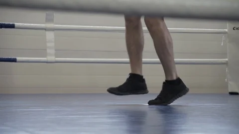 Box training - a man standing on the ring and jumping over the jumping rope Stock Footage 127152039