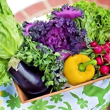 A box of vegetables on a table Stock Photos