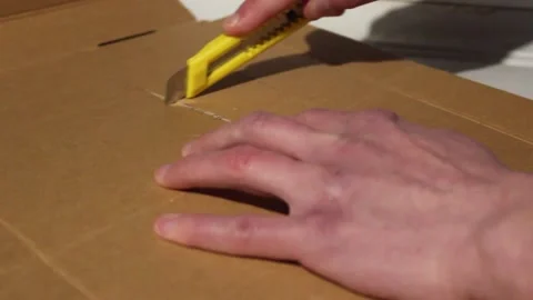 Boxcutter On Cardboard Stock Footage 264702885