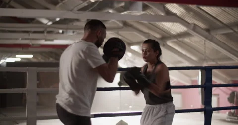 Boxer and trainer practicing punches Stock Footage 228442193