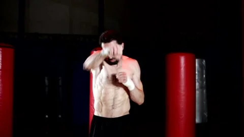 Boxer with a beard trains by throwing punches in the gym. Stock Footage 139887660