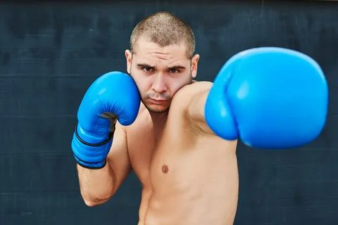 Boxer in blue gloves Stock Photos