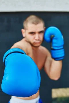 Boxer in blue gloves Stock Photos