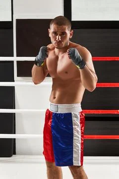 Boxer in blue gloves warming up in the ring Stock Photos