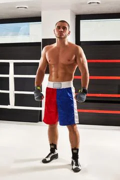 Boxer in blue gloves warming up in the ring Stock Photos