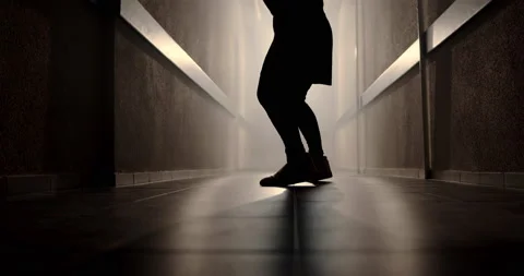 A boxer in a dark corridor with a backlight behind his back is fighting a shadow Stock Footage 157898387