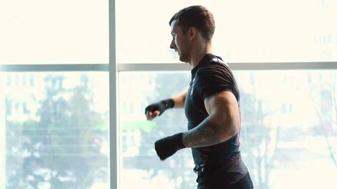 Boxer doing fight with shadow in gym Stock Footage 100713249