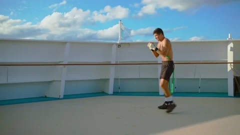 Boxer exercising box workout and shadow boxing with resistance band training Stock Footage 194160205