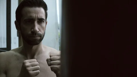 Boxer exercising with a punching bag Stock Footage 127437935
