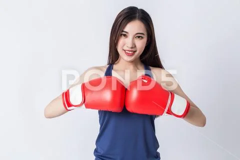 Boxer - fitness woman boxing wearing boxing gloves. Stock Photos