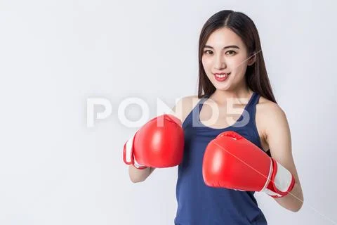 Boxer - fitness woman boxing wearing boxing gloves. Stock Photos