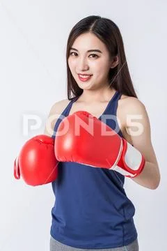Boxer - fitness woman boxing wearing boxing gloves. Stock Photos