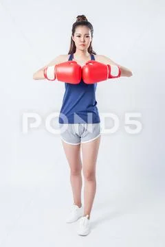 Boxer - fitness woman boxing wearing boxing gloves. Stock Photos