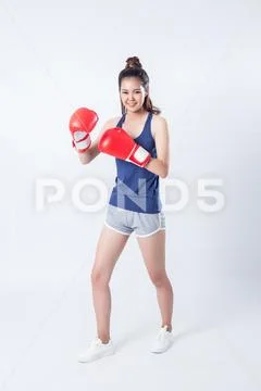 Boxer - fitness woman boxing wearing boxing gloves. Stock Photos