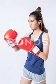 Boxer - fitness woman boxing wearing boxing gloves. Stock Photos