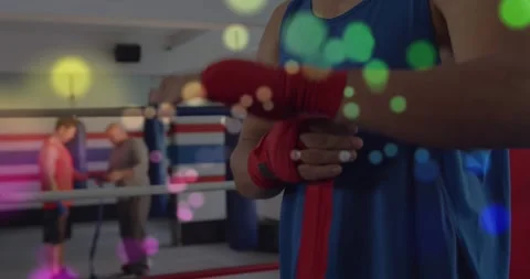 Boxer grabbing red wrap and wrapping hands, threading thumb and tightening for Stock Footage 332289483