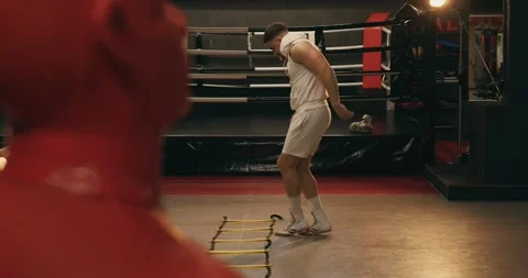 Boxer in gym doing leg exercises on coordination stairs. Stock Footage 275276338