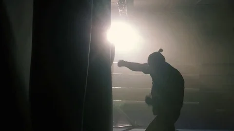 Boxer hit punching bag sweat drops fall Stock Footage 72458675