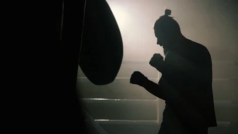 Boxer hit punching bag sweat drops fall Stock Footage 72459591